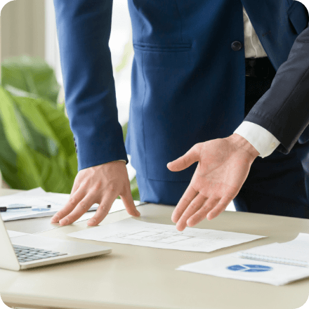 real estate agent showing house plan buyer